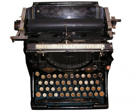 Black old-fashioned type writer with round metal keys
