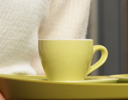 A lime green tea cup on a lime green tray