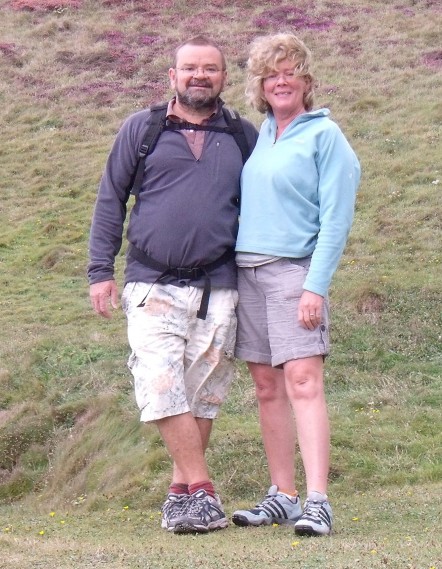 Jeremy and Judy out hiking together in shorts, fleeces and boots.