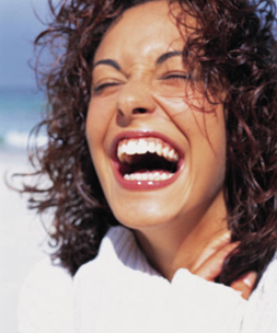 Woman in white jumper laughing