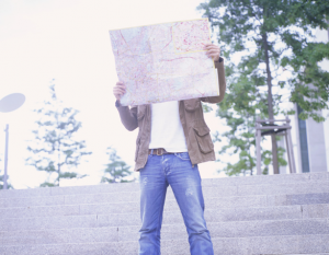 Man holding a map in front of his face