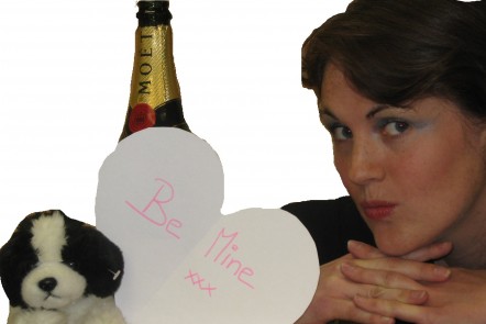 Woman posing with cuddly toy and champagne to mimic photoshoot