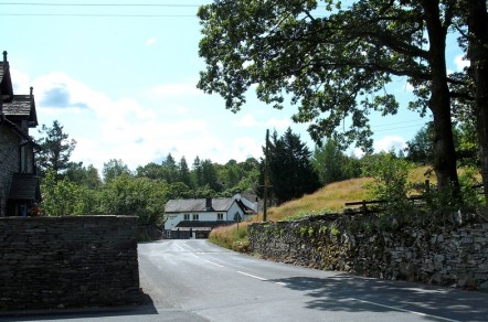 A view from the road of a village pub and some trees