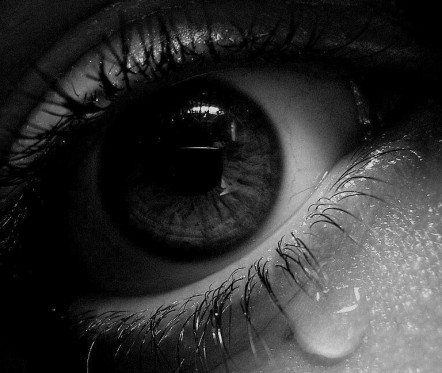 Black and white photo of a crying eye
