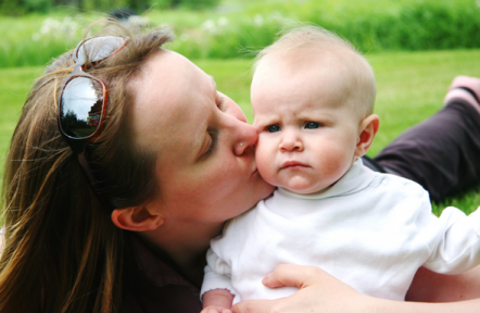 Woman kissing baby