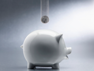 A white piggy bank on a grey background