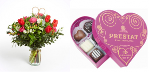 Photo of a bouquet or red flowers and chocolates in a pink heart shaped box