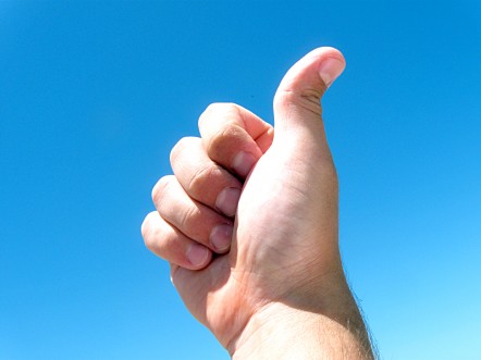 Man with thumbs up against a blue background